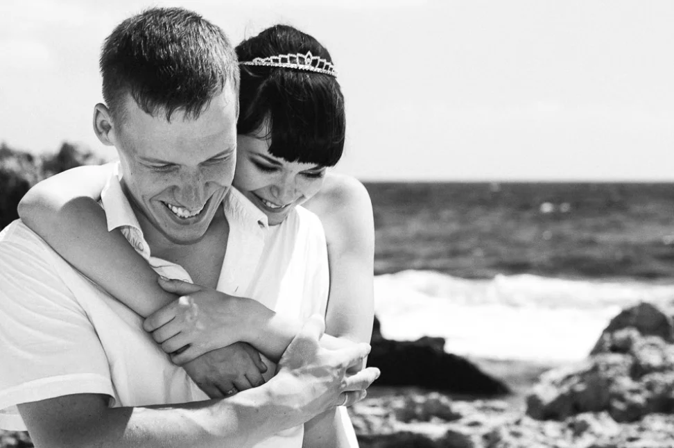 Black and white portrait of bride and groom smiling