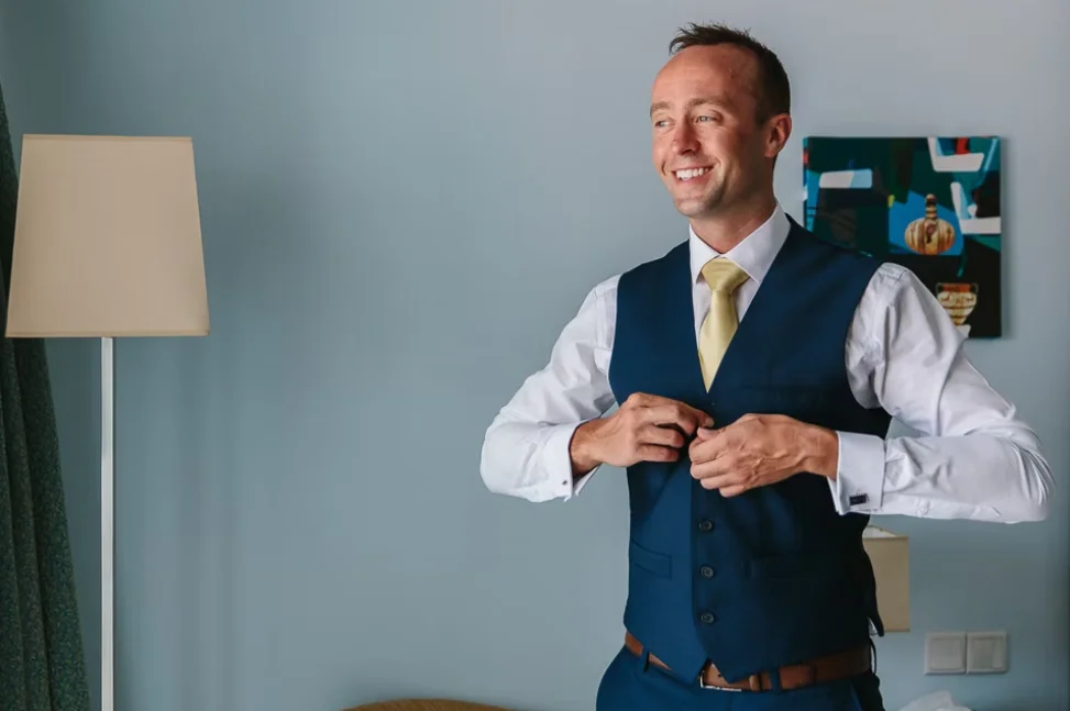 Cheerful groom preparing for the wedding day