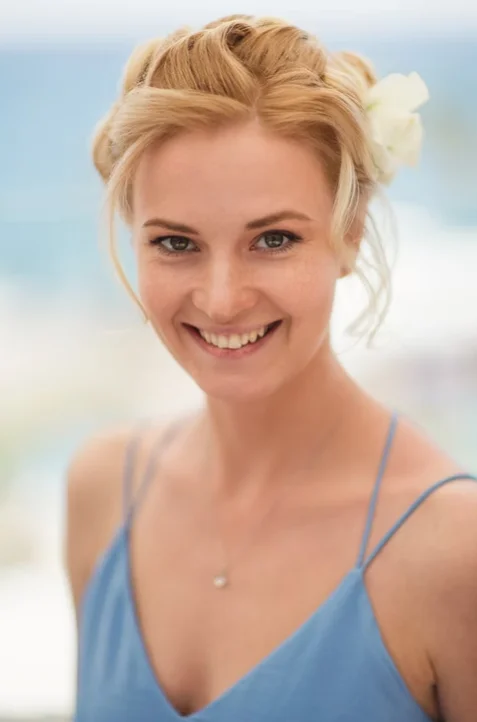 Woman smiling at the camera with flower in her hair