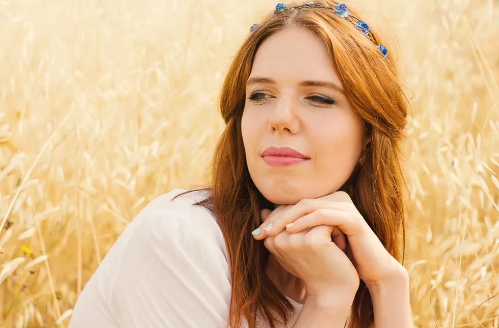 Woman looking into the distance with flowers in her hair