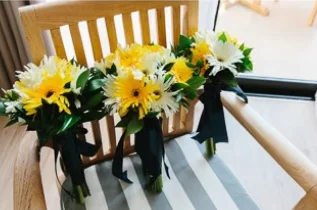 Yellow and white flowers bouquet and greenery