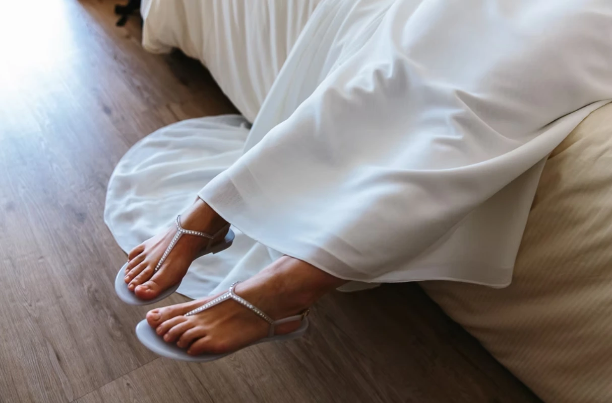 Brides feet wearing white shoes