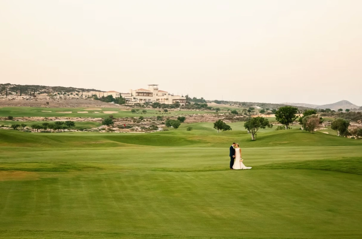 Wide shot of bride and groom in the countryside