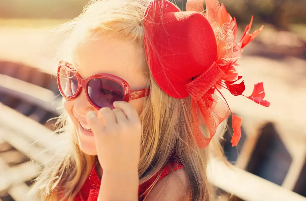 Happy child wearing red sunglasses